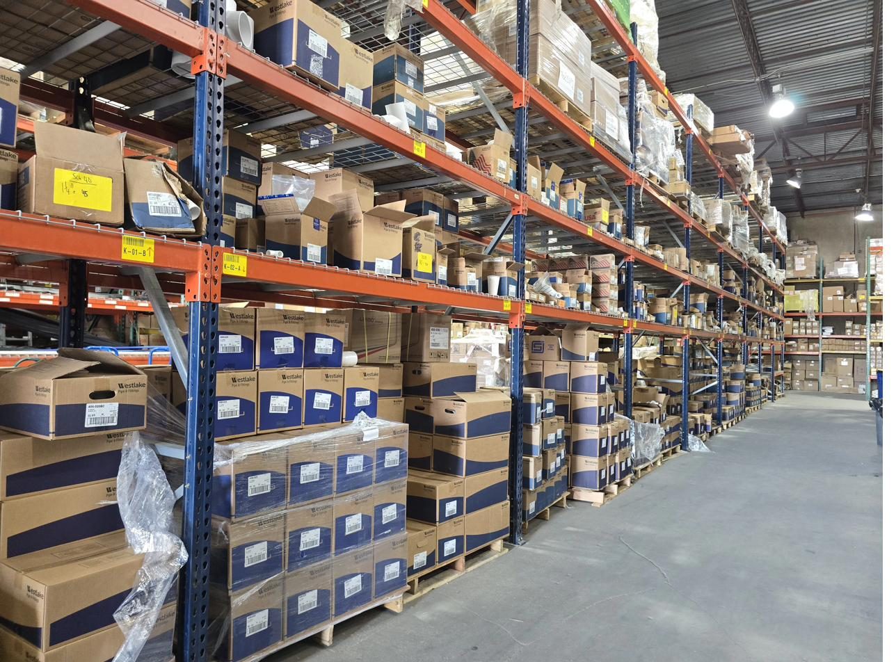 Aisles of PVC pipe fittings stocked in our Carrollton warehouse